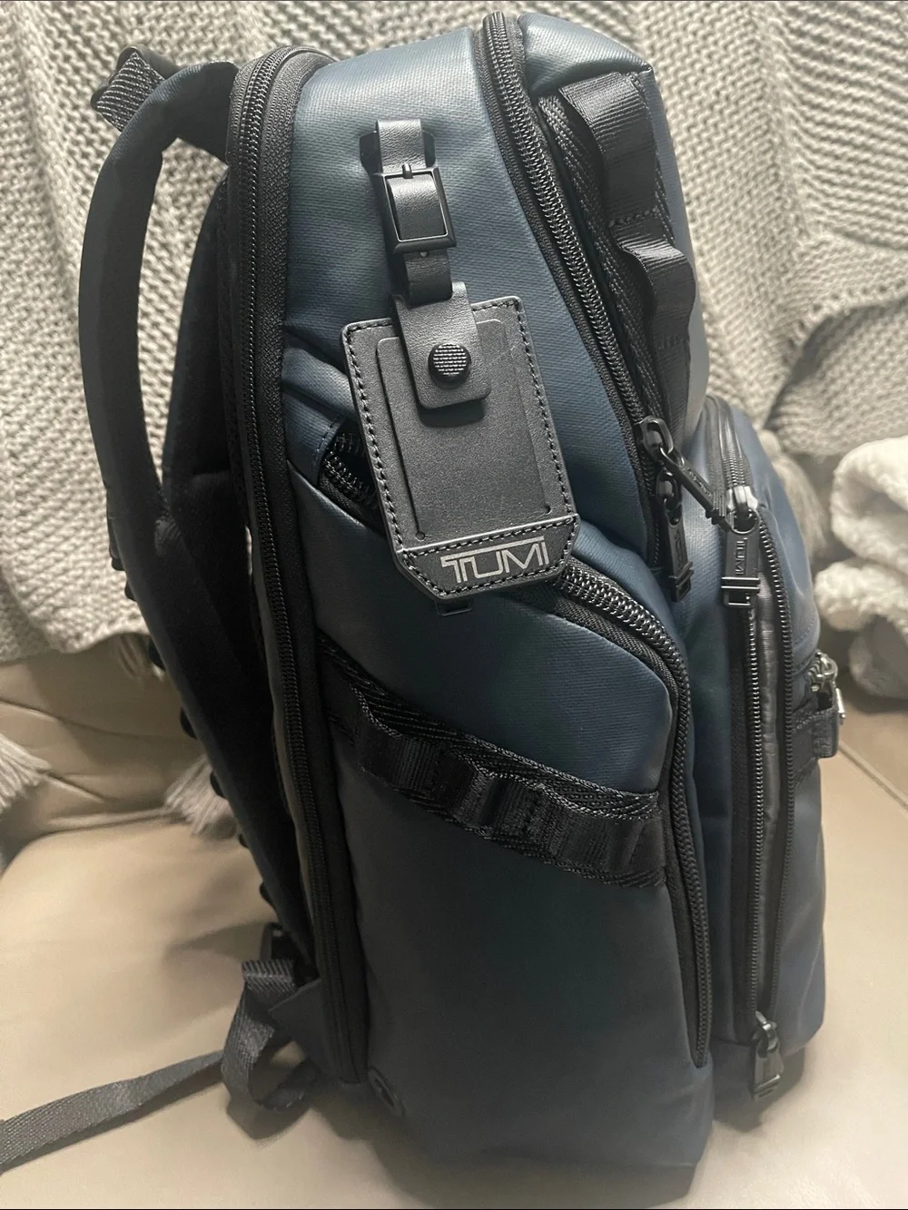 Tumi Men's Blue Travel Backpack with Front Zip Pocket.  It has never been used